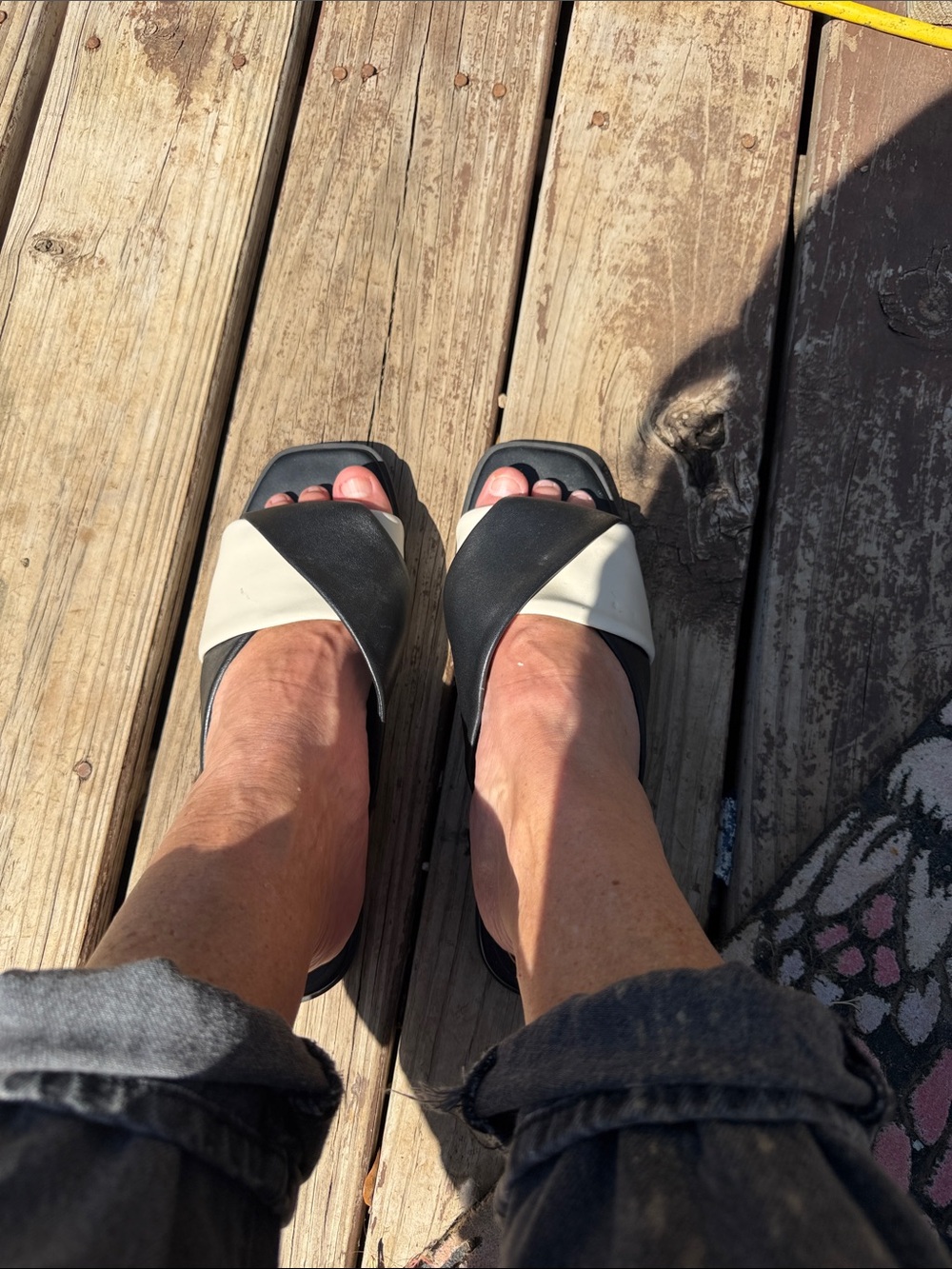 Vionic Two-Tone Black and Cream Crossover Slide Mules